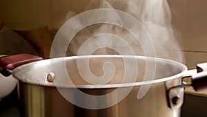 Macro shot of hot steam flowing from pot with cooking soup