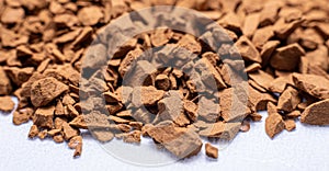 Macro shot of instant coffee granules on a white background