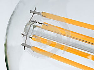 Macro shot of LED Filament type lamp on white background