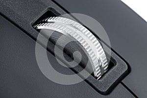 A macro shot of a metal roller from a modern wireless computer mouse.