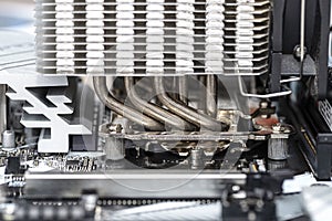 Macro shot of a modern desktop motherboard with a heatsink mounted on the CPU on the socket LGA.
