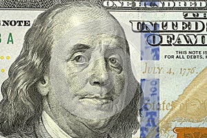 Macro shot of a new 100 dollar bill, portrait of US president Benjamin Franklin. 100 dollar bill with a close-up