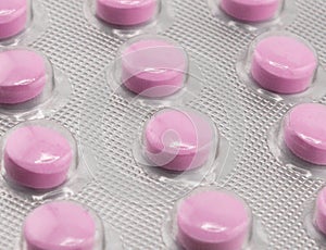 Macro shot pile of tablets pill in silver blister packaging isolated on white background. Aluminium foil blister pack. Pharmacy