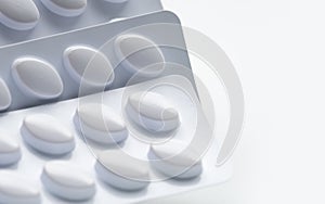 Macro shot of pills in white blister pack for light resistance photo