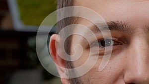 Macro shot portrait of male model showing one eye on camera