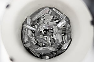 Macro shot of pure zinc telluride element crystals in a container