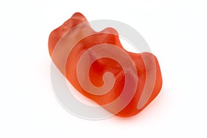 A macro shot of a red gummy bear, isolated on a white background.