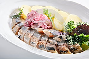Raw Salted Soused Herring with Onions and Potato Isolated photo