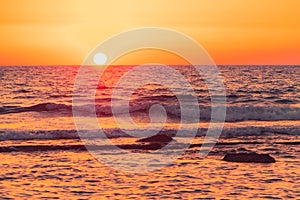 Macro shot of the sea and orange sunset.