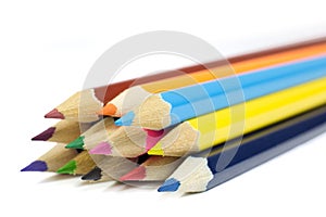 Macro Shot of Sharpened Colorful Pencils Coming from Corner Isolated on White