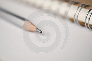 Macro shot of sharpened pencil on white paper