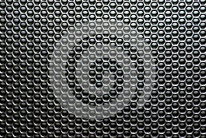 Macro shot of a speaker grille.