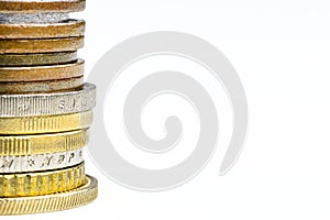 A macro shot of a stack of coins stacked in a bar, isolated on a white background, with space for text on the right.