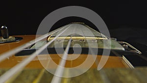 Macro shot through strings on an electric guitar that is laying down