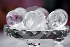 Macro shot of transparent crystal balls with colorful ornaments and sun reflections in it