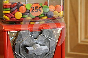 Macro shot of vending machine with crank and candy 25 cents