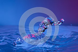 Macro shot of water drop collision with abstract effect against a blue background