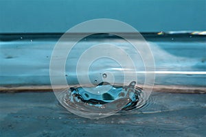 Macro shot of water drop making ripples in water