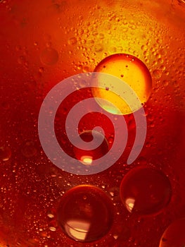 Macro shot of water drops on a glass with orange and red background