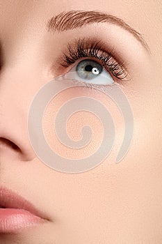 Macro shot of woman's beautiful eye with extremely long eyelashes. view, sensual look. Female eye with long eyelashes