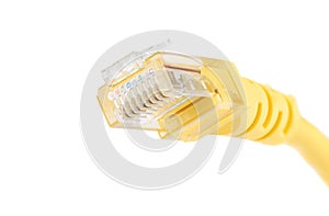 Macro shot of a yellow Ethernet cable for a LAN network connection with an RJ-45 network connection plug.