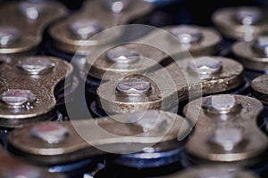 Macro shots black-golden colour motorcycle chains close-up