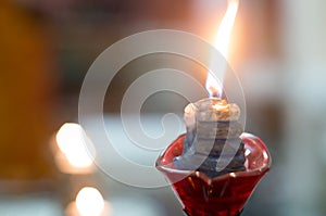 Macro shots of diyas being lit by hand or candle for the hindu religious festival of Diwali.