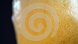 Macro slow motion footage shot,Pour the beer into the glass until the beer bubbles over the glass.