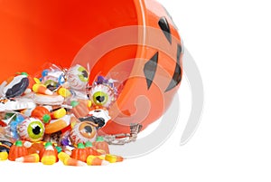 Macro spilled halloween candy and pumpkin bucket