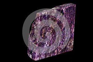 Macro of a stone Charoite mineral on a black background