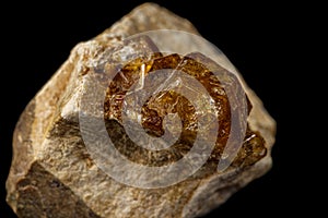 Macro stone Grossular mineral on a black background