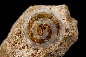 Macro stone Grossular mineral on a black background