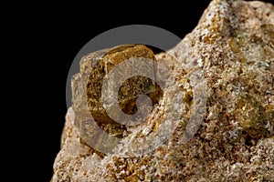 Macro stone Grossular mineral on a black background