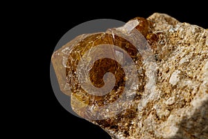 Macro stone Grossular mineral on a black background