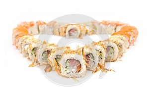 Macro of sushi rolls set isolated on on white background. Sushi served in food heart shape.