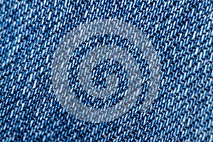 Macro texture of blue denim. Close-up with selective focus. Original background