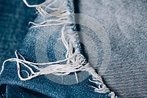 Macro texture of jeans hole and threads