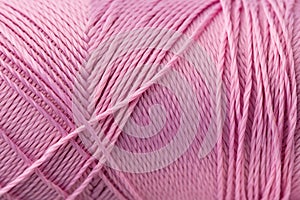 Macro texture of pink silk luxury thread, close-up, copy space. Macro Photography of a coil with threads. Sewing