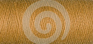 macro texture of a skein of orange sewing thread