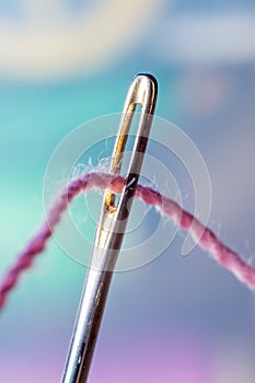 Macro of a thread through needle eye