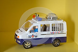 Macro of a toy police car. Police car on yellow background