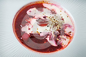 macro ukrainian borscht decorated with sour cream and wheat sprouts