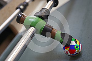 Macro of a unity in a foosball table flagged with country flag.