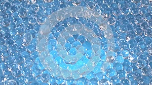 A macro universe of hydrogel beads, their translucent forms gleaming with reflected light, presenting a vision of modern