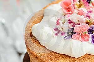 Macro of Victoria Sponge Cake with Whipped Cream and Sugared Flowers