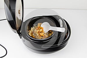 Macro video of a multicooker. The man opens the pan and mixes the dish. The concept of cooking automation and ease in the kitchen.