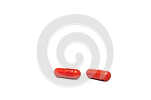 Macro view of brown capsule pill isolated over white background