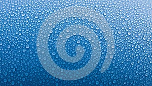 Macro view of countless tiny water droplets on a textured blue surface