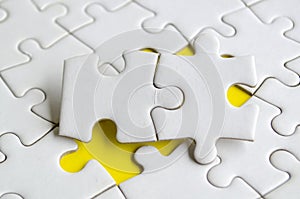 Macro view of empty white jigsaw puzzle with customizable space for text or ideas