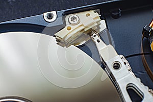 Macro view of an HDD head resting on a disk platter and its reflection